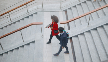 Top view of two businesspeople going down the stairs