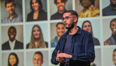 Developing young entrepreneurs: Thoughtful young man speaking on stage
