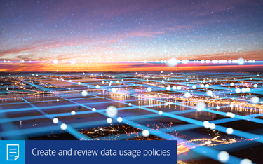 “Create and review data usage policies” A digital grid above an urban landscape at sunset.