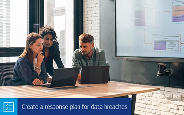 “Create a response plan for data breaches” Two women and a man looking at computer laptops in a conference room.