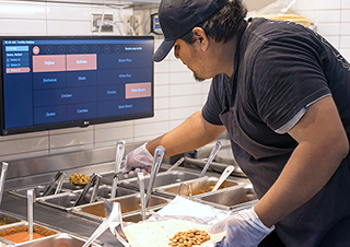 Chipotle employee preparing food