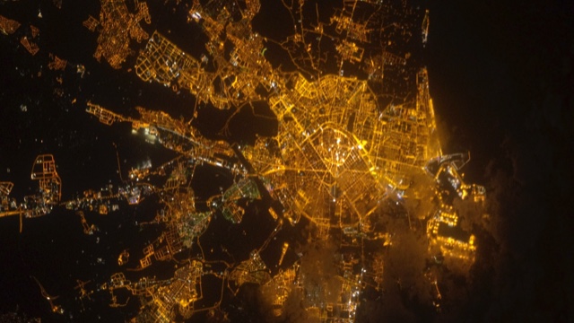 Satellite view at night of orange cityscape lights