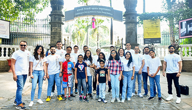 A group of employees and students posing for group photo.