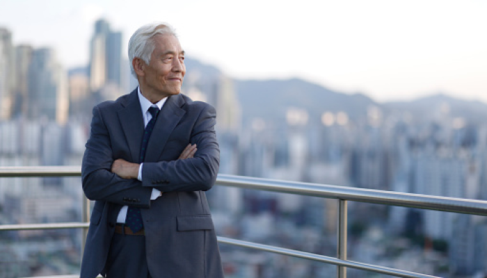 Man in a suit looking ahead