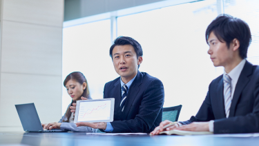 Three people in a business meeting