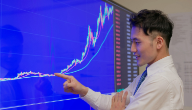 A man pointing at a stock chart