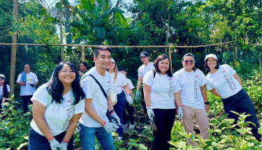 Supporting sustainable farming: A group of volunteers with tools in a garden