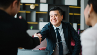 A businessman shaking hands with another businessman