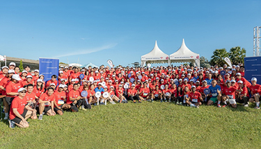 A group of employees posing for group photo