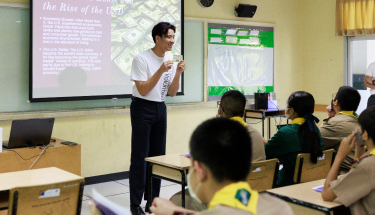 Enhancing educational experience: Volunteers in front of a classroom