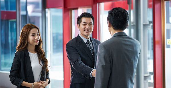 Business people shaking hands with a client