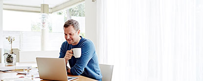 Man sitting at desk with coffee