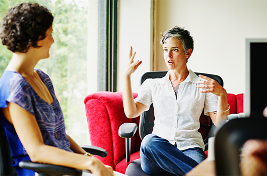 Woman talking to two other women