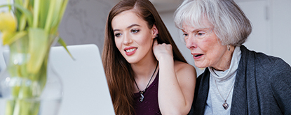 two women looking at a computer