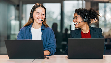 two women answering calls in a call center