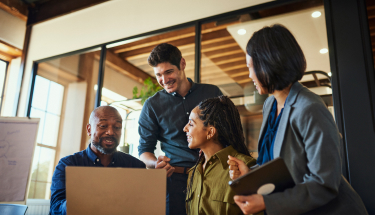 A small business gathering at a laptop